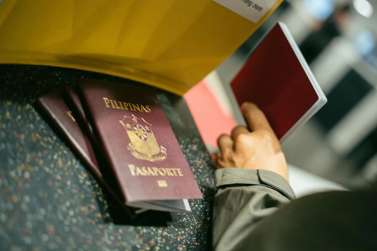 A passport and international documents on a desk with a globe, representing an affidavit of translation for documents in another language