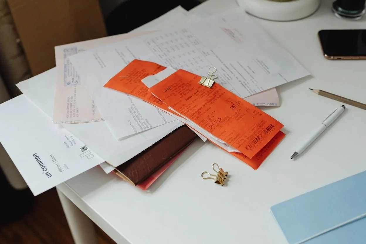 A printed letter of invitation, a photocopied citizenship card, and a Notice of Assessment laid out together on a desk for an Ottawa Super Visa file