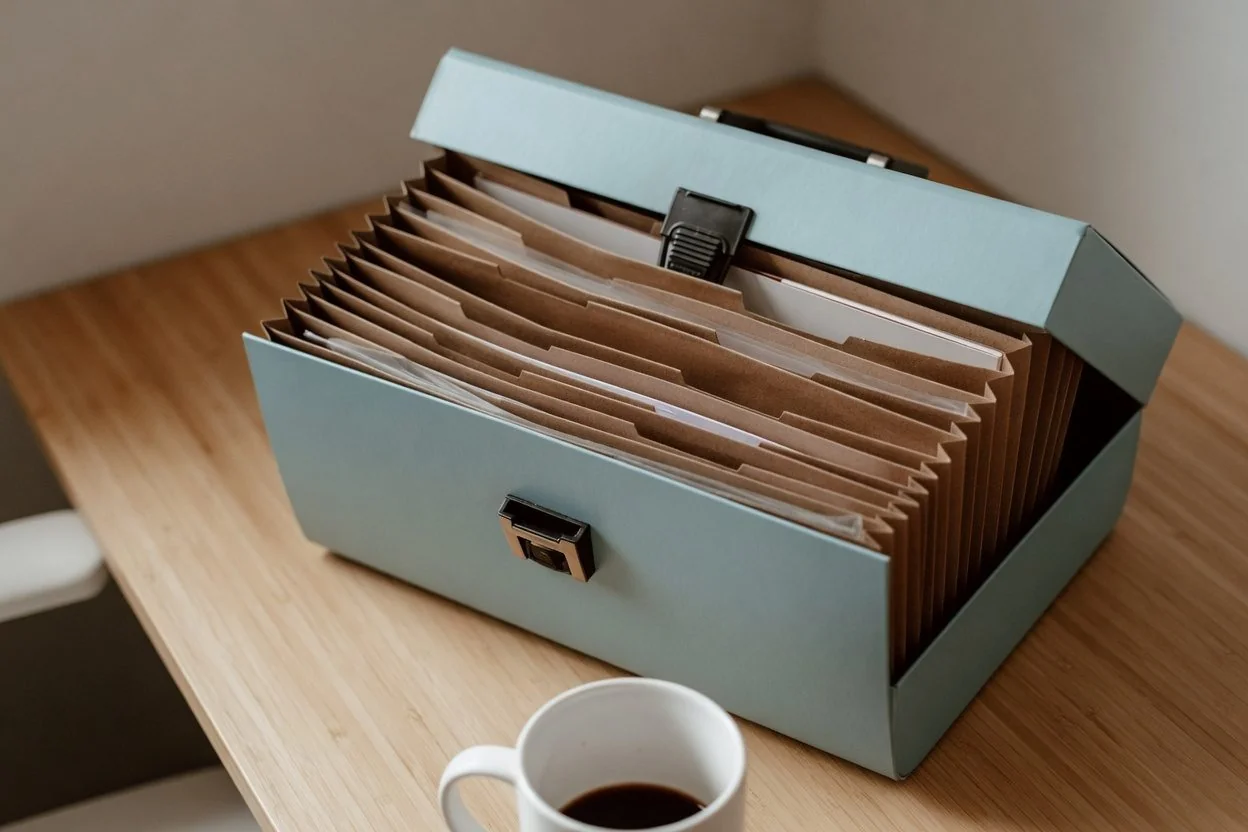 Folder of documents and a driver's licence on a wooden desk, ready for a notary appointment in Ottawa