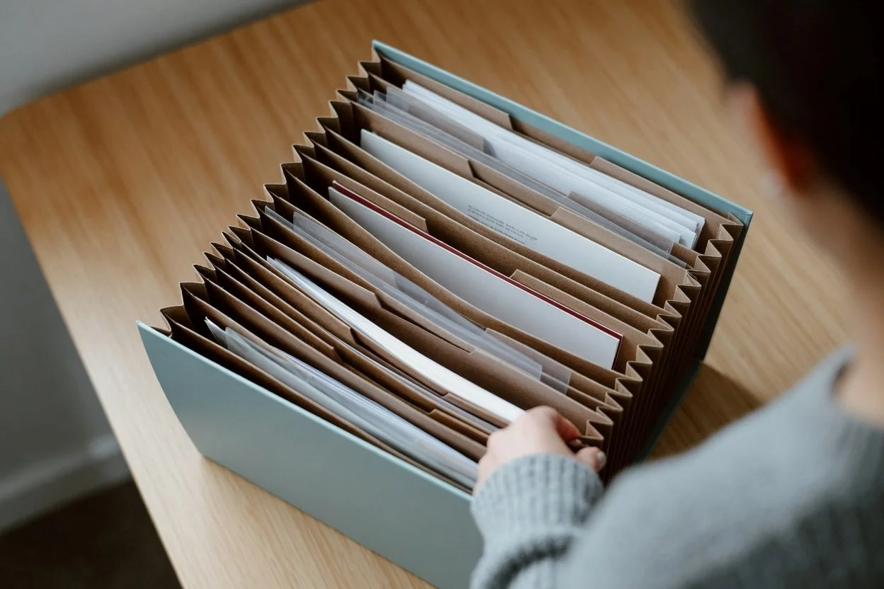 A grantor's folder containing a drafted property POA, a drafted personal-care POA, government photo ID, and a doctor's capacity letter, ready for an Ottawa notary appointment