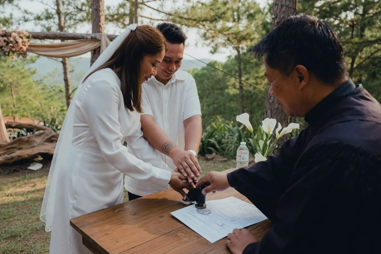 Couple reviewing wedding paperwork with passports and a notarized declaration on a sunlit Ottawa desk