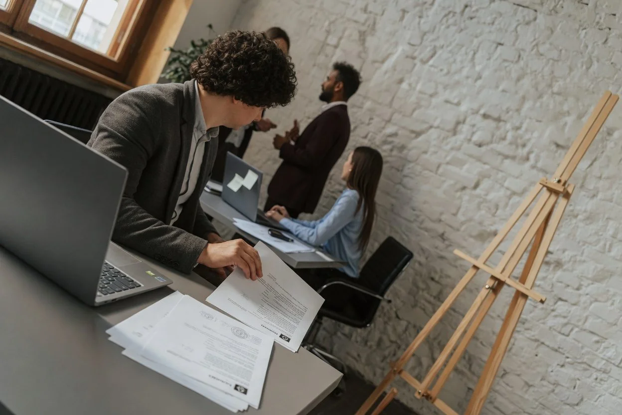 A person looking stressed over paperwork at a desk, illustrating why a notary refuses to notarize a document